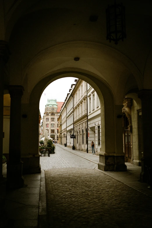 a dark street has a large archway