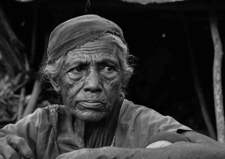 an old woman with wrinkles sitting down