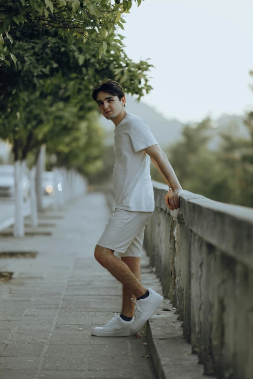 a man standing on the edge of a stone road