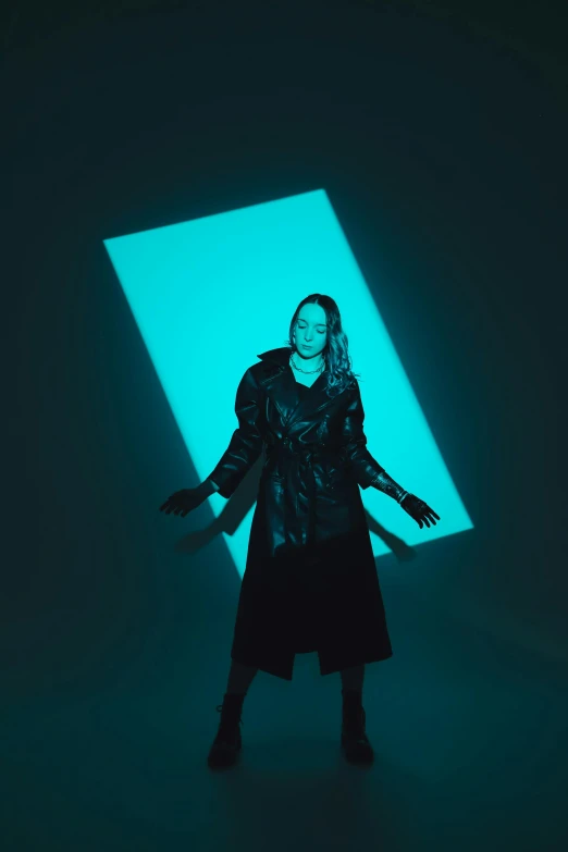 a woman in black dress standing in a blue light