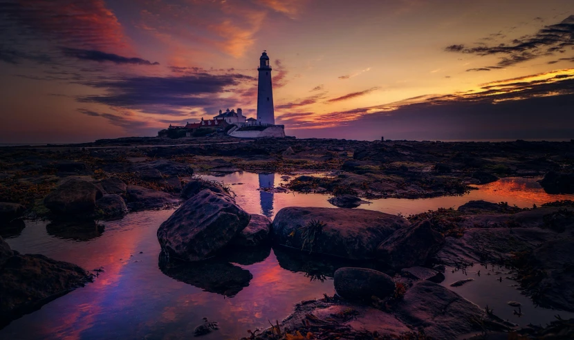 a large lighthouse sitting on top of a body of water