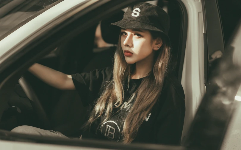 a woman sitting in the driver seat of a car