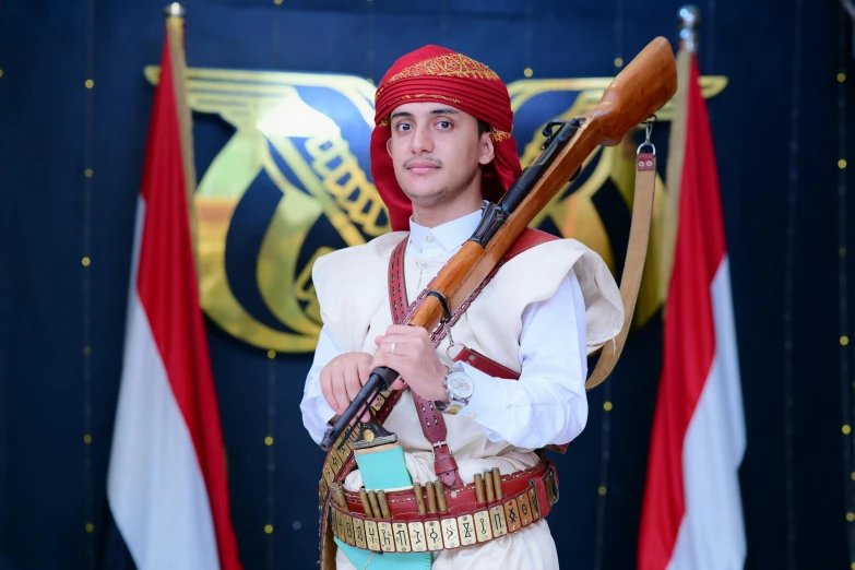 a man in red and white dressed with an antique gun in his left hand