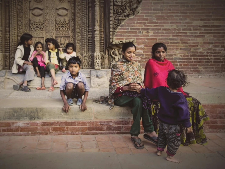 a group of children and adults on the steps