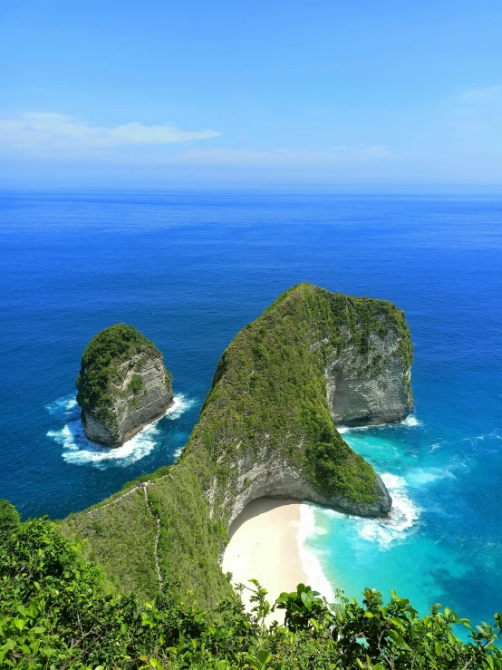 the beach is surrounded by large rock formations