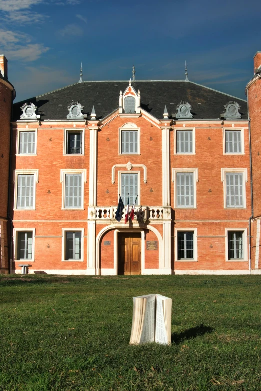 a red brick building that has been built with white trim