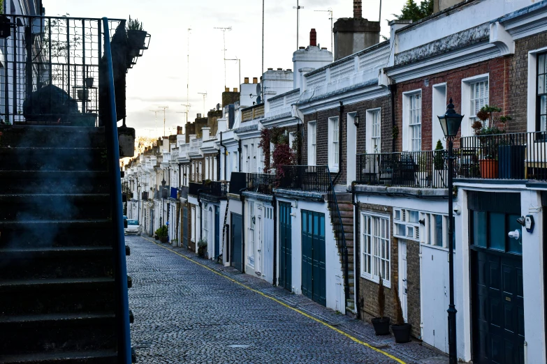 a narrow city street with houses lined along side