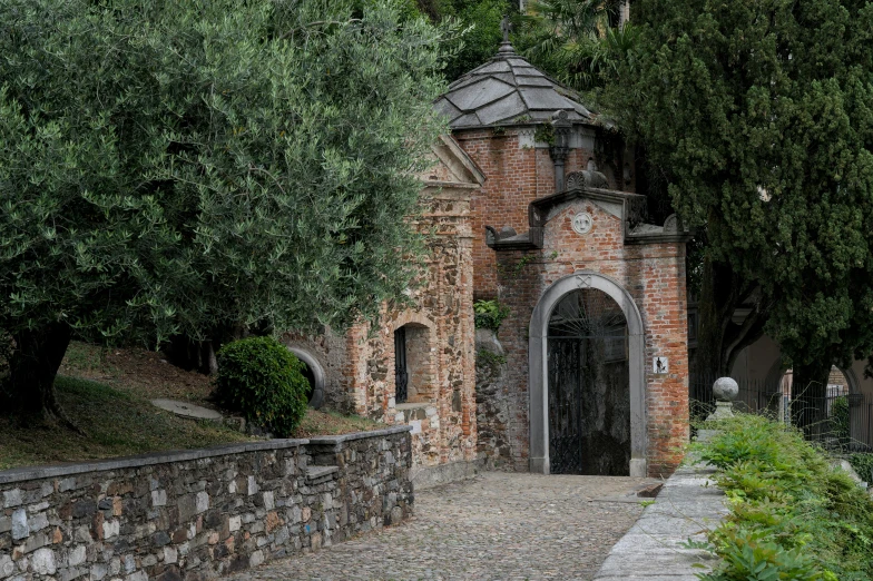 an old stone building with a gate between two buildings