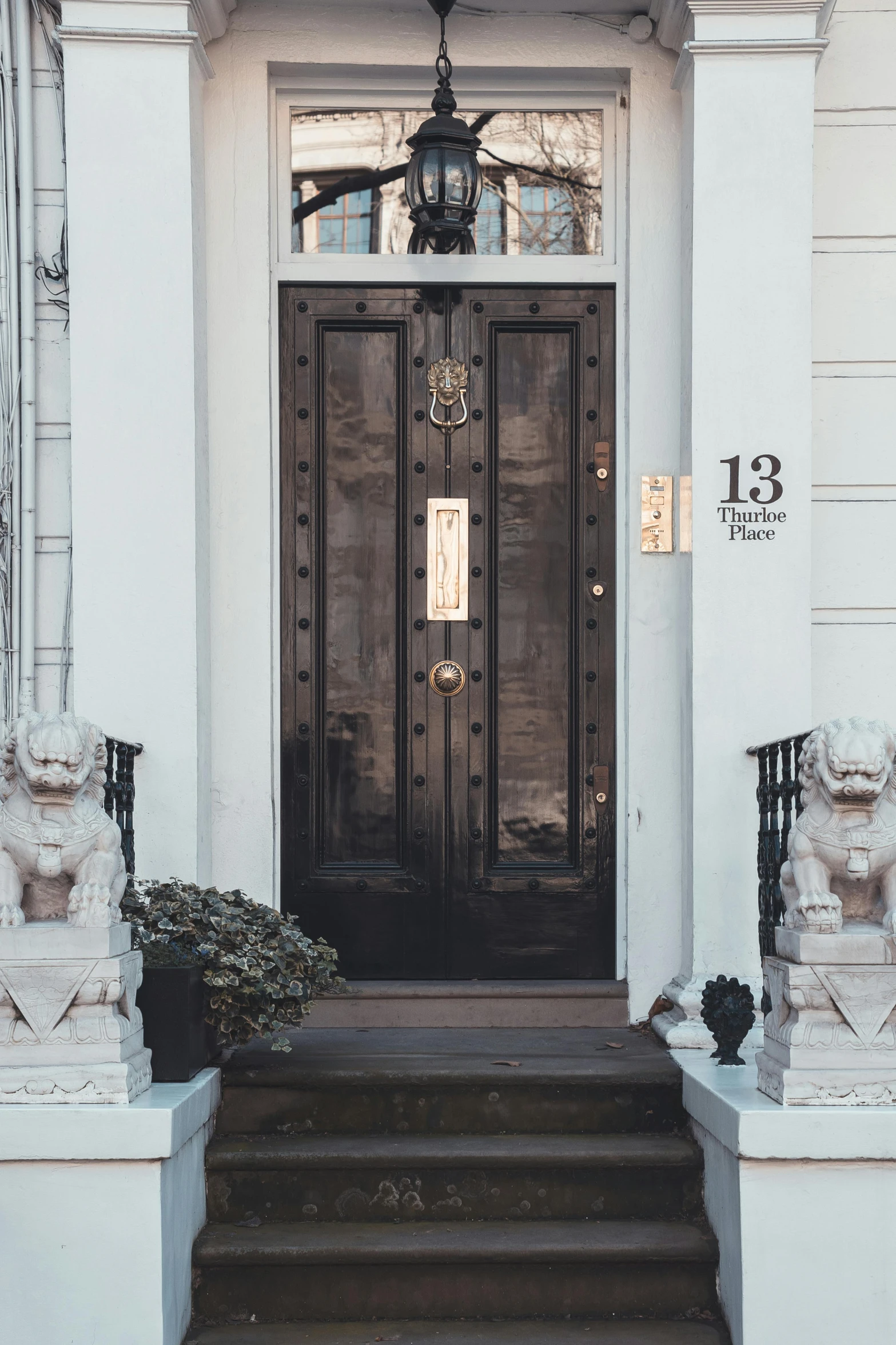 an entry way with stairs and decorative outdoor lighting