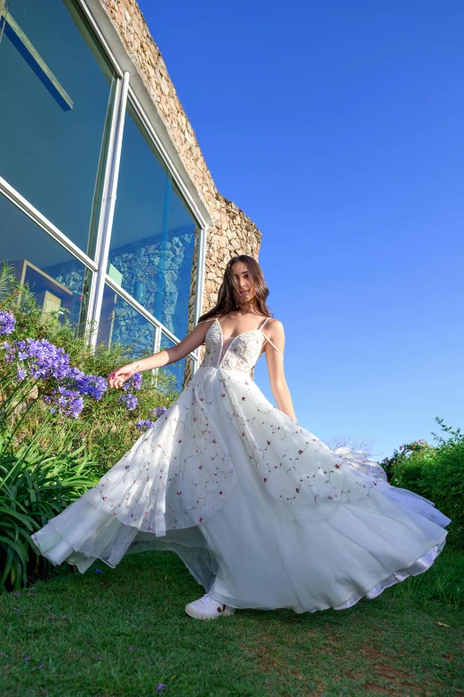 a woman is walking outside in a dress