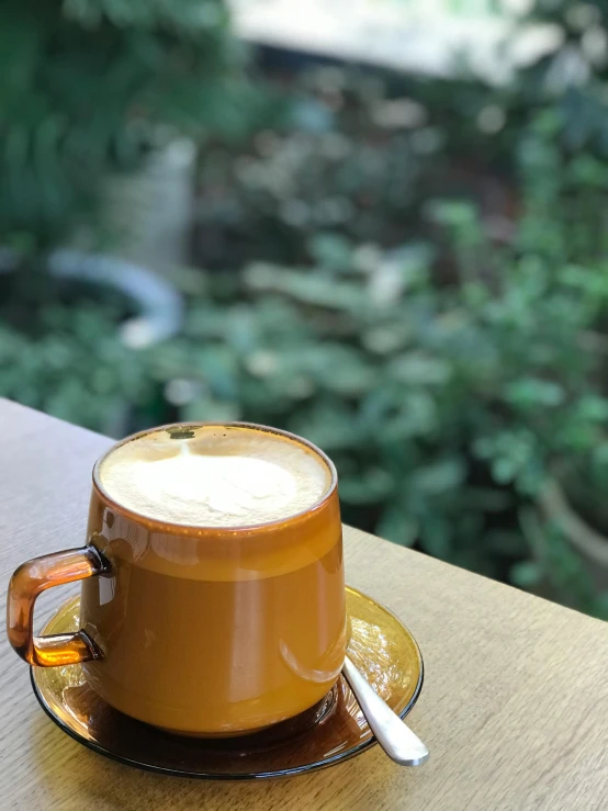 a coffee cup sits on a wooden table