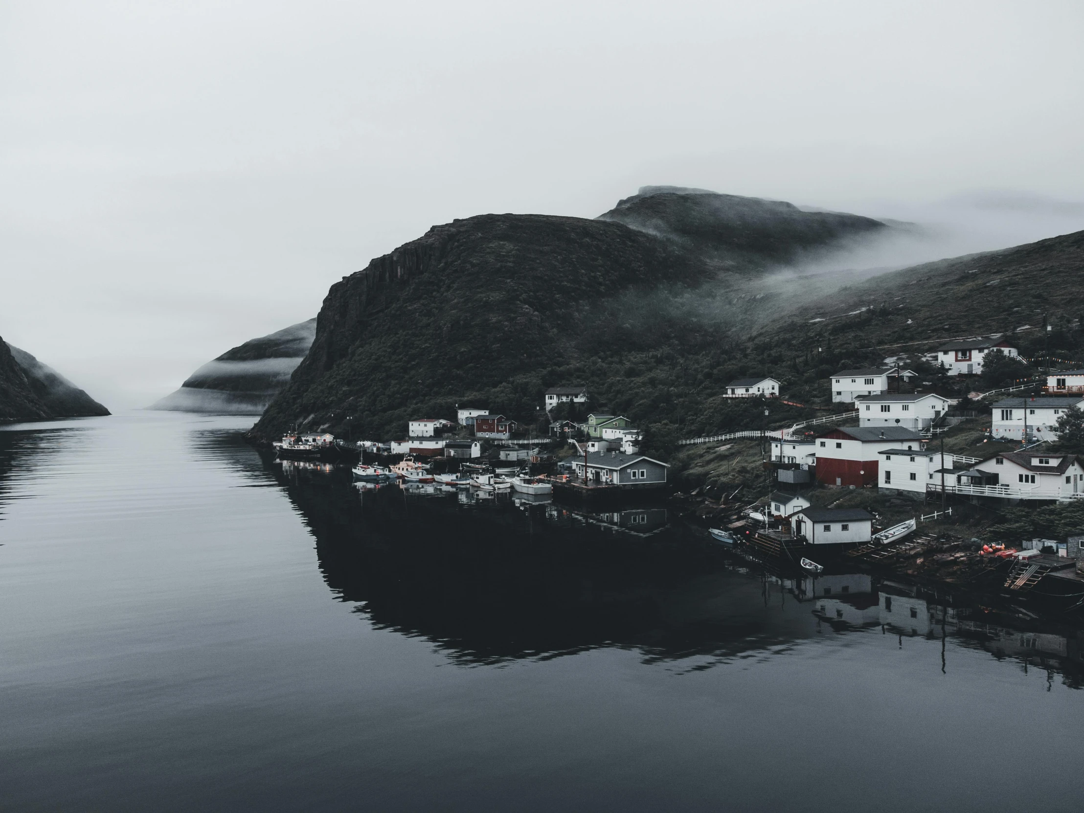 houses on the shore in a sea and mountains