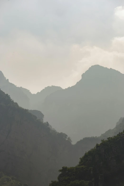 hazy mountain scene with a group of people on a boat in the water