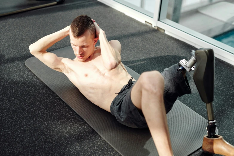 a shirtless man is doing a yoga pose