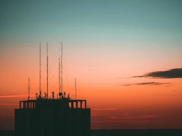 a tall structure sitting on top of a sky filled with clouds