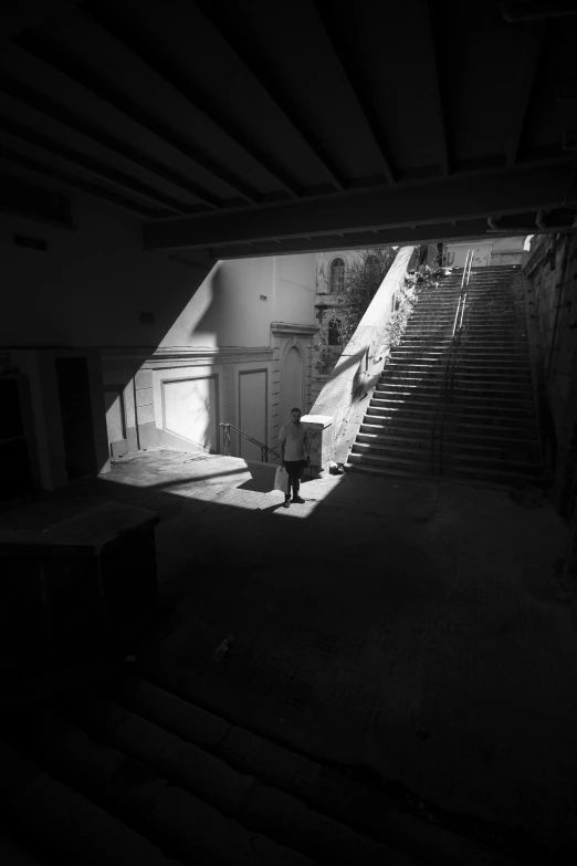 a person standing near some steps in a room