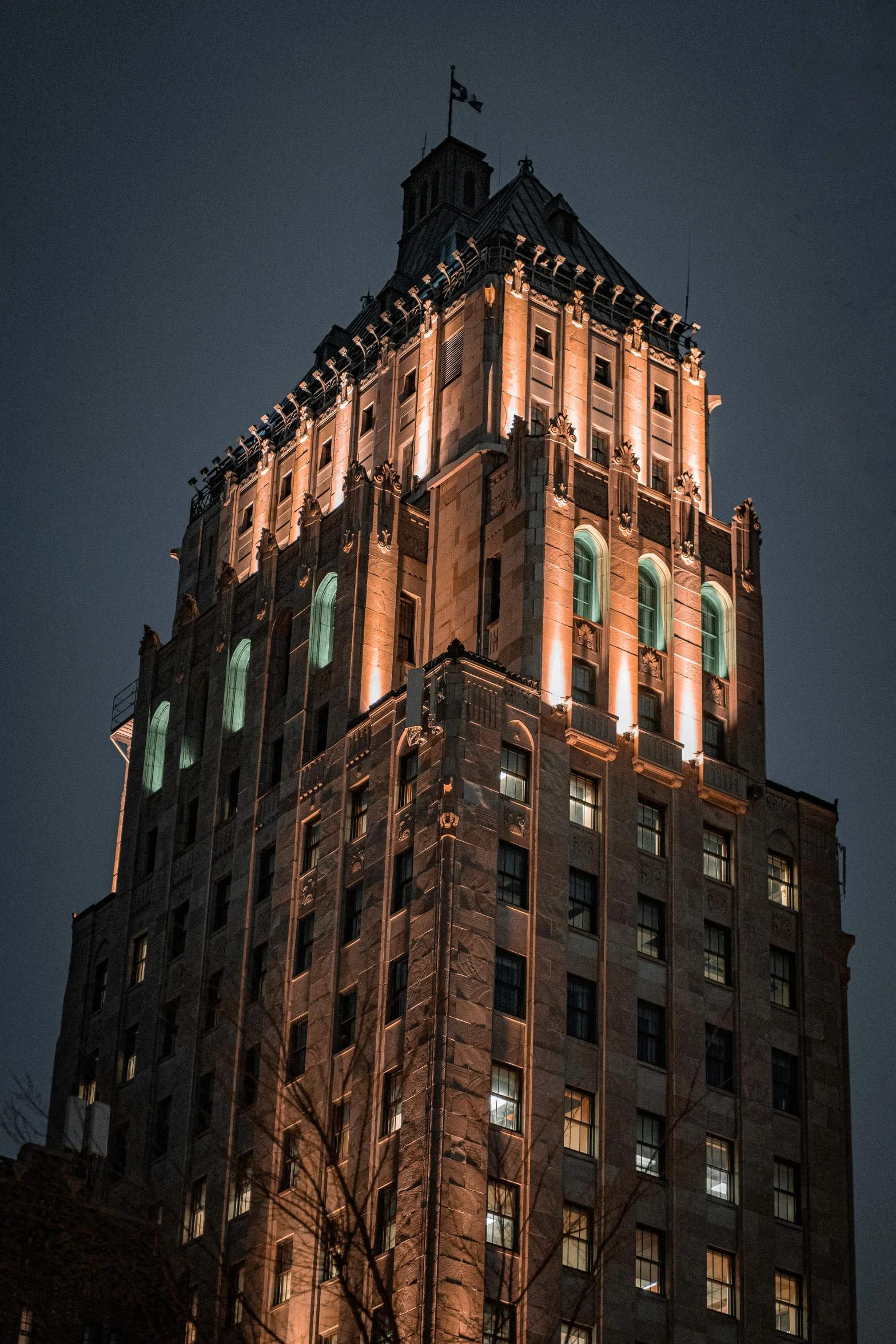 a tall building lit up with lights in the middle