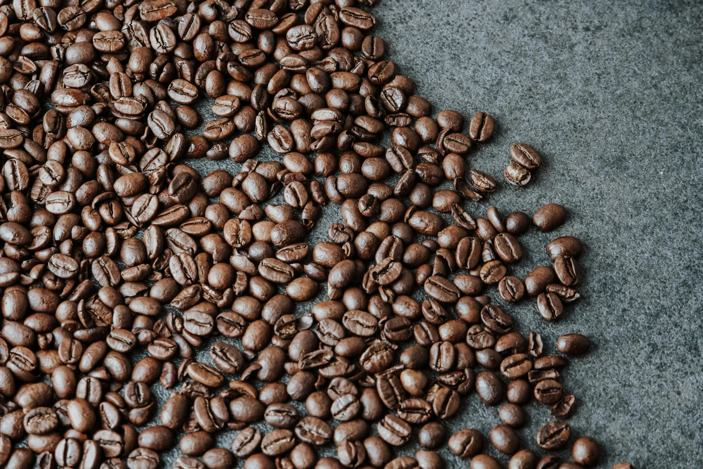 lots of coffee beans sitting on top of a counter