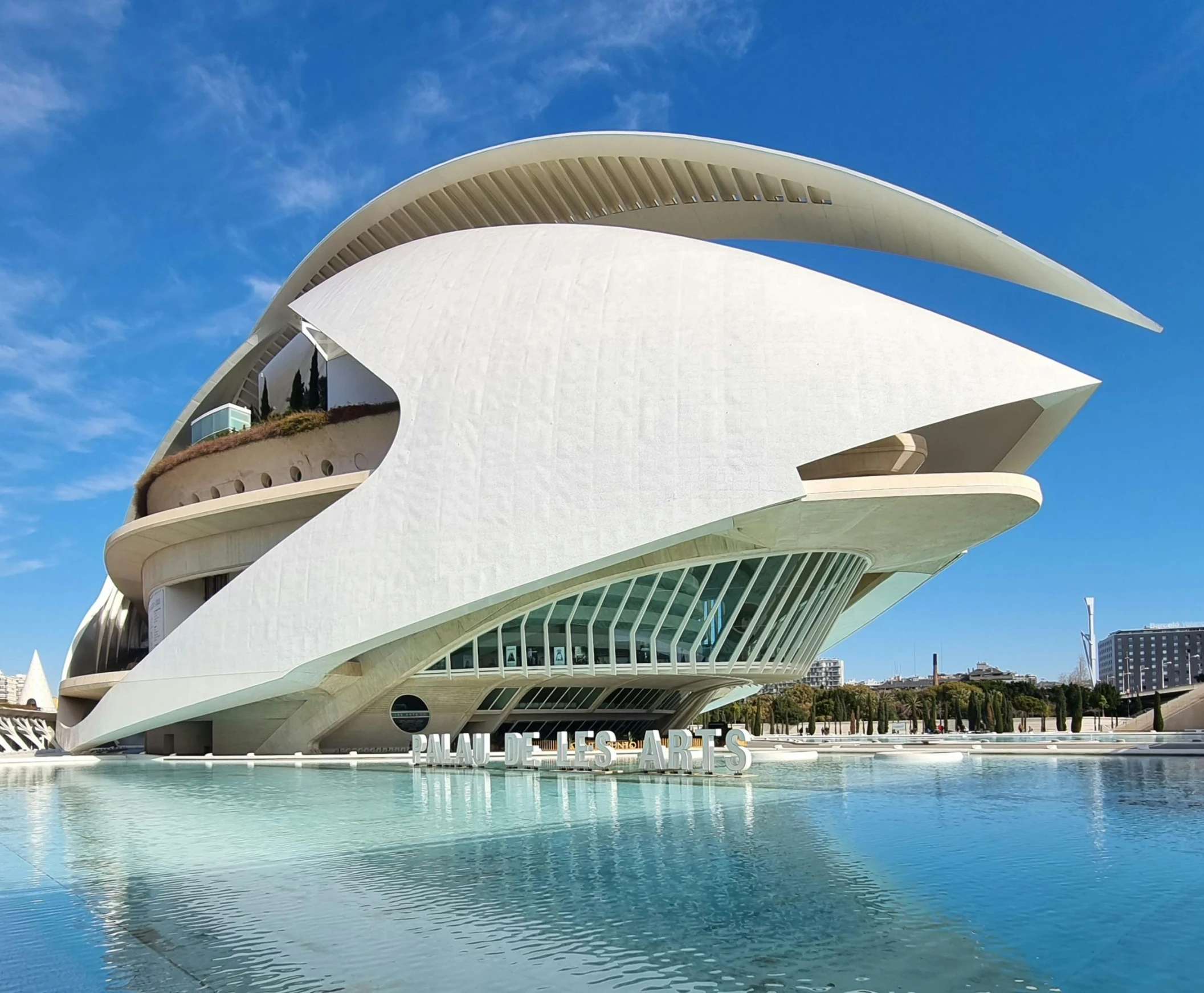 a modern building next to a large pool of water