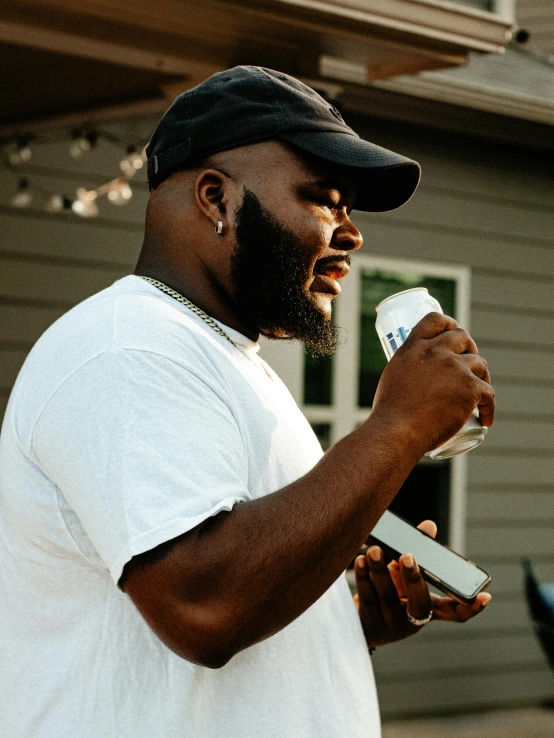 the man is holding a paper, and looking away