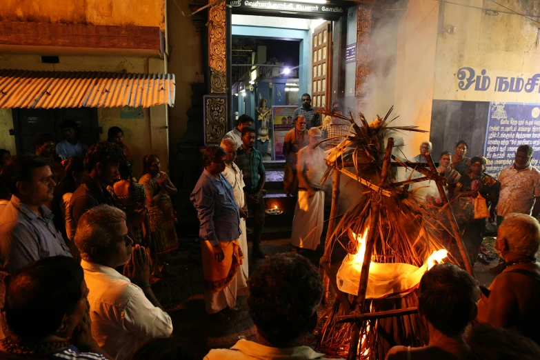 people stand around with flames coming out of it