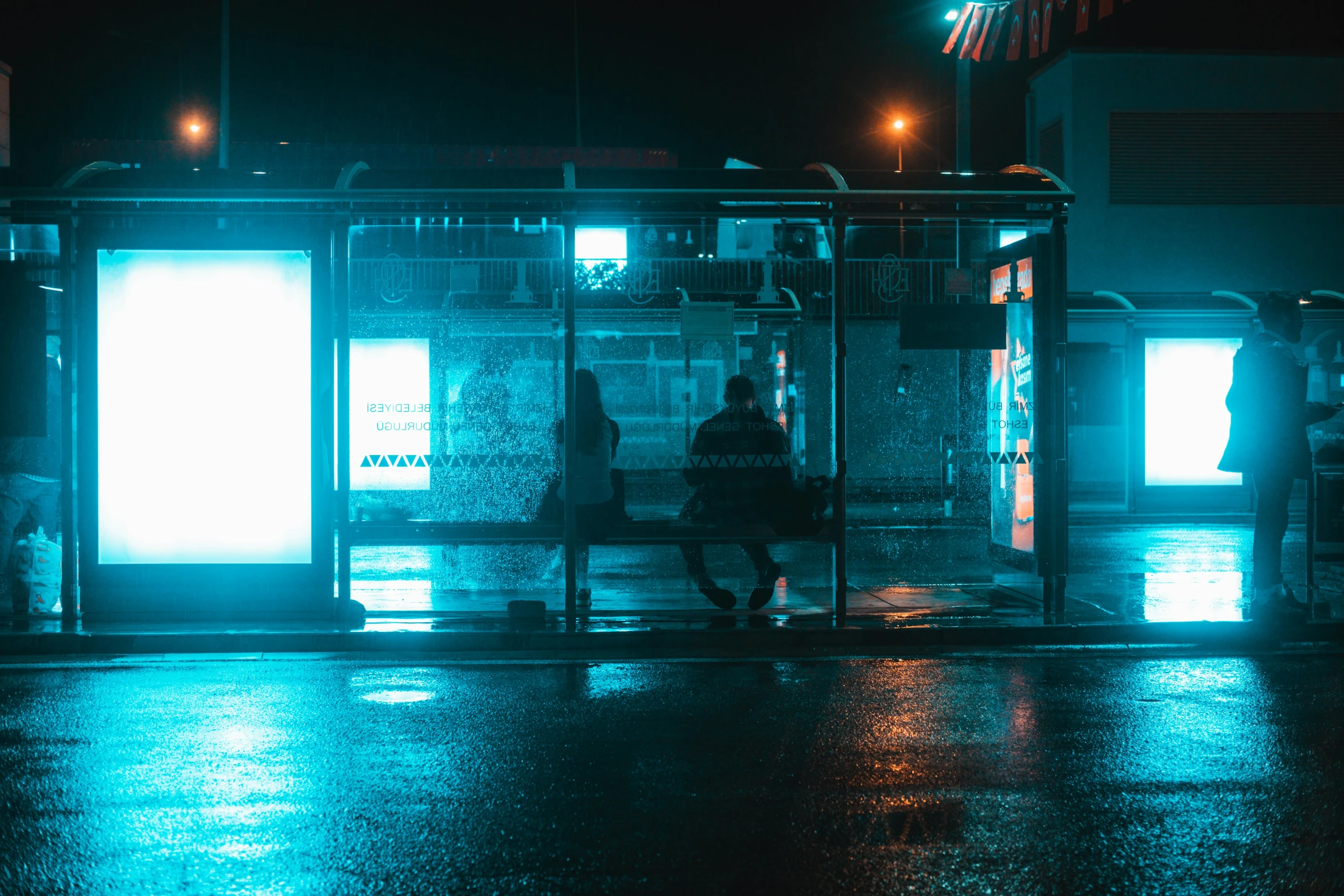 a person on a bench in the dark near some windows