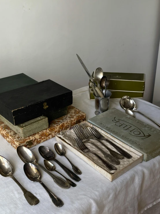 a table has spoons and utensils on it