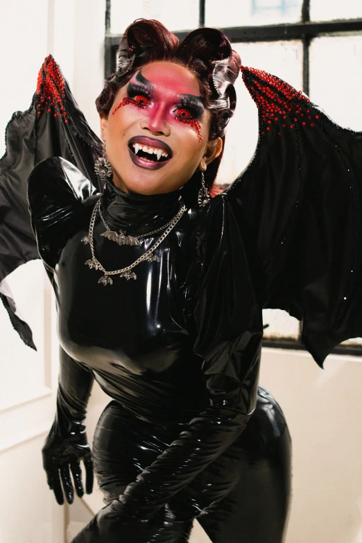 a woman in black catsuits with fangs