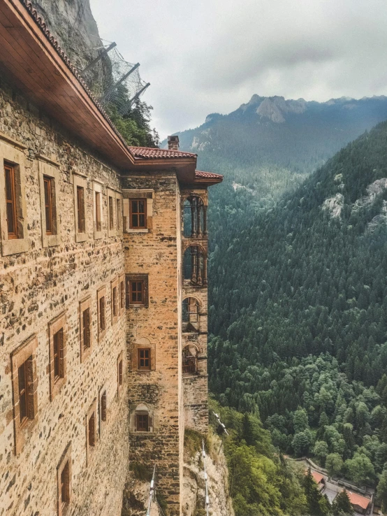 looking down on a stone building in a mountainous area