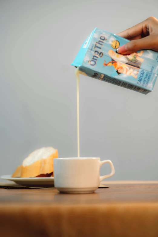 someone pouring coffee in a cup with the cream