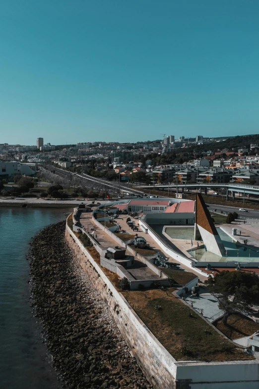 the aerial view of an empty parking lot by the water