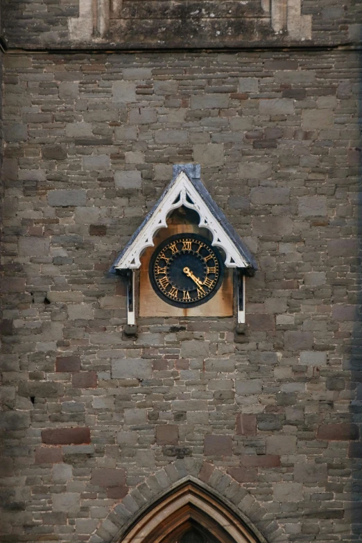 the clock is built on a brick wall