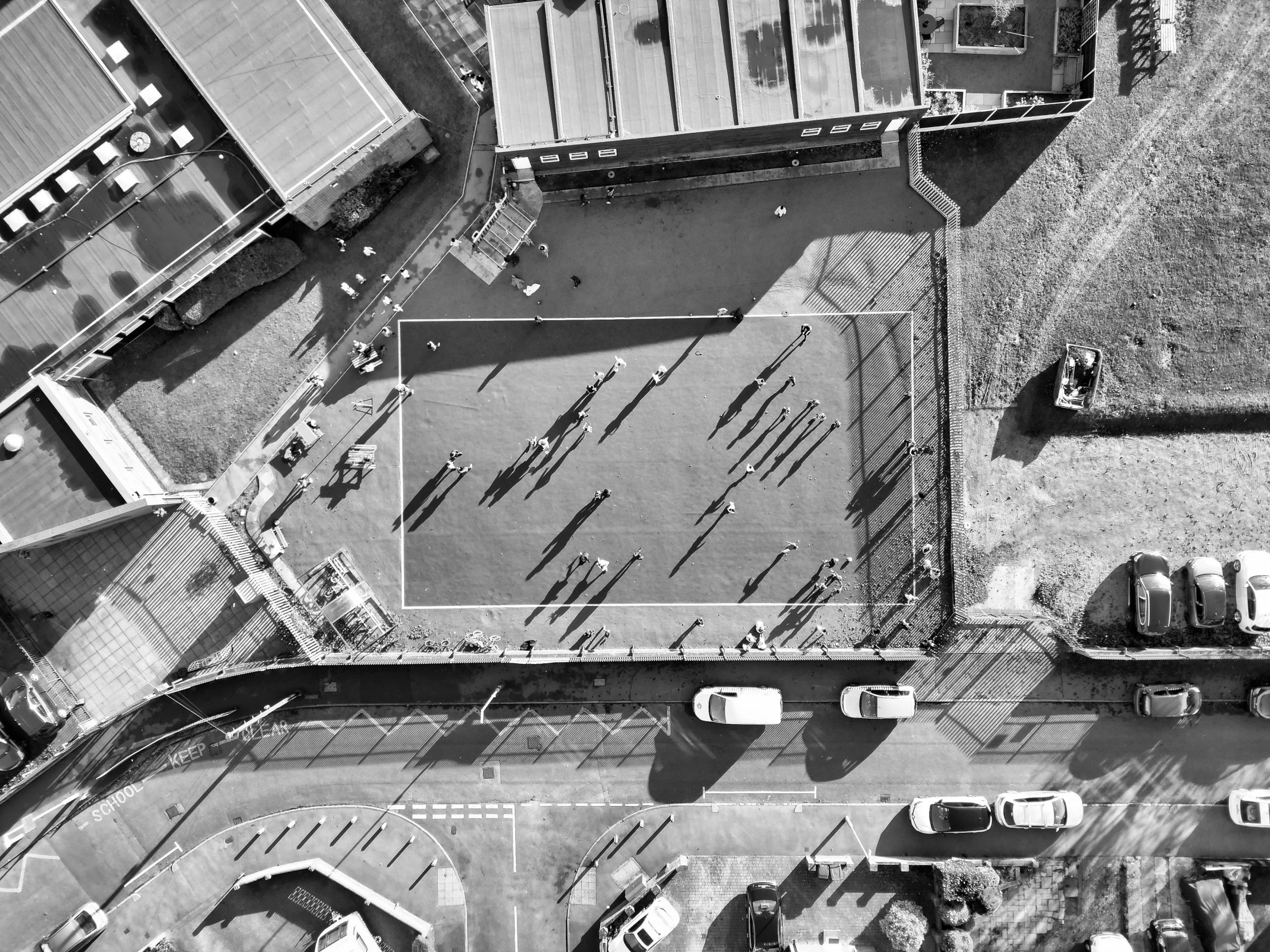 an aerial view of several boats and vehicles