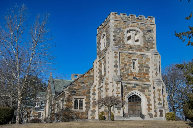 the very large tower of the building has many windows