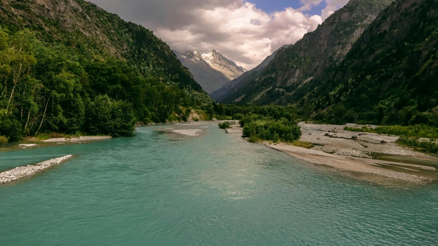 a view of a valley with water near rocks