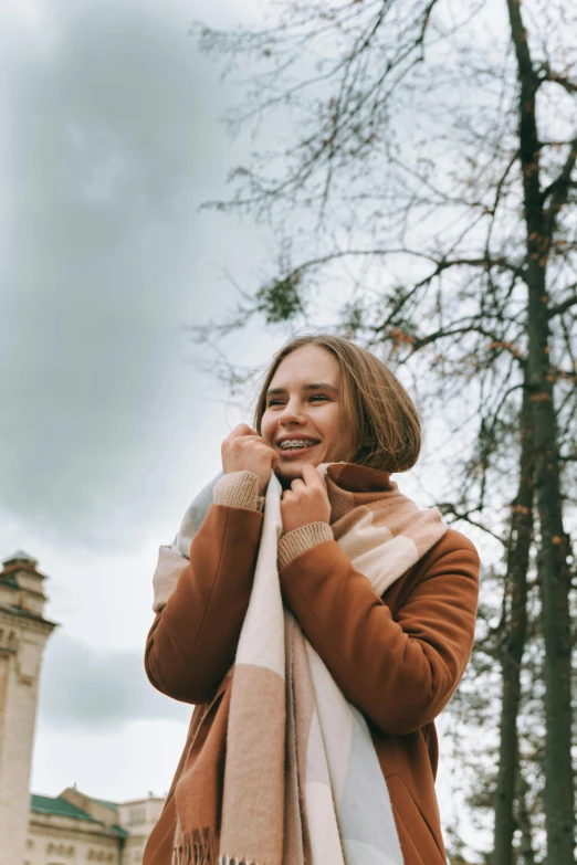 a woman wearing a scarf talks on her cell phone