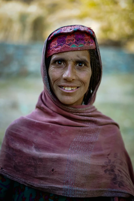 a woman in a hijab standing with her head covered