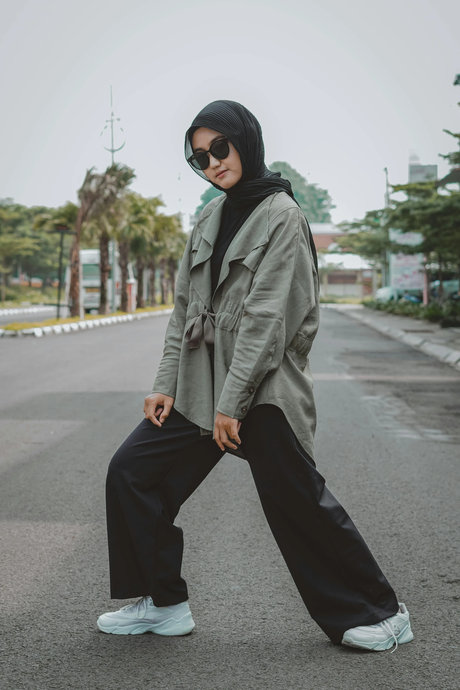 a person in black jacket and sneakers on a street