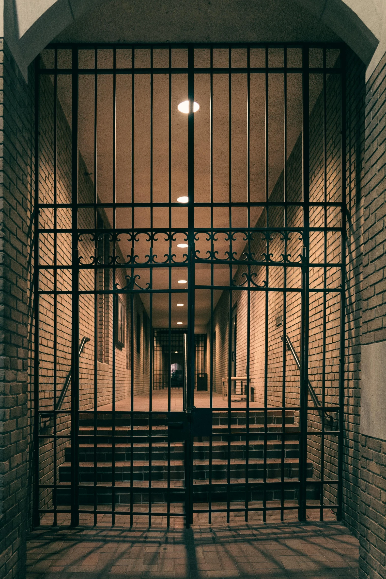 the door to a  cell with black bars