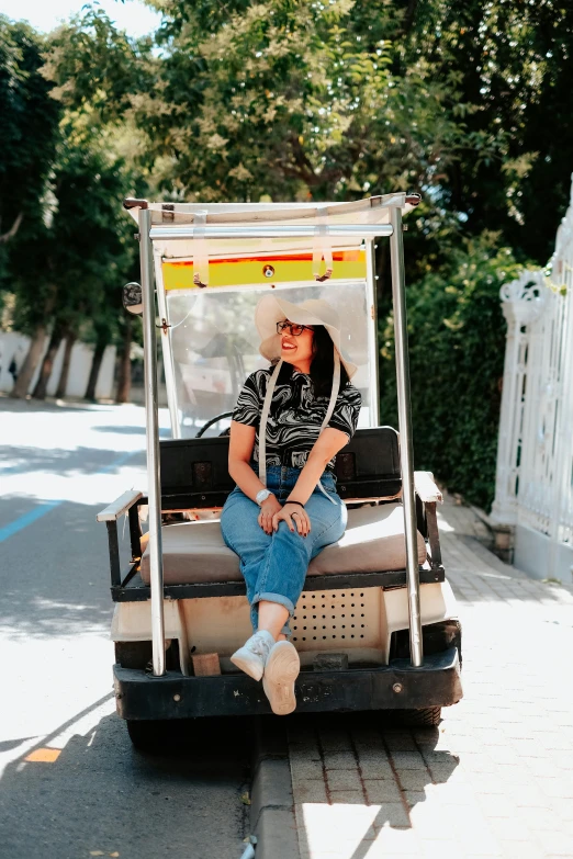 a man and a woman sit on a golf cart