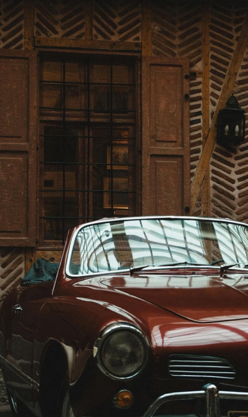 a red car parked in front of an old building