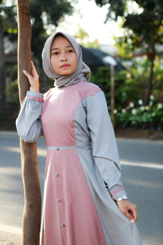 a woman in hijab walking down the street