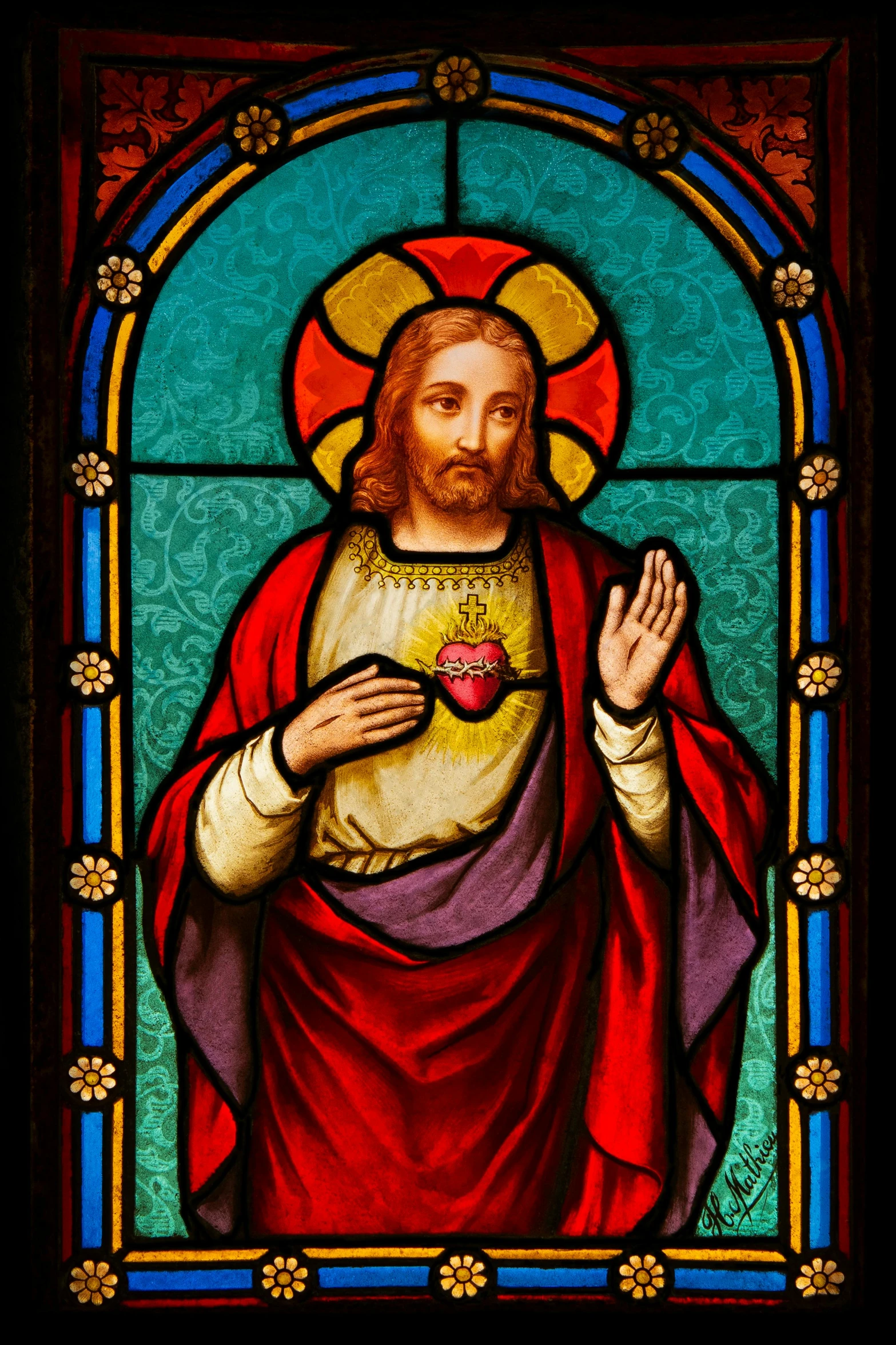 stained glass with a painting of jesus holding his hands up