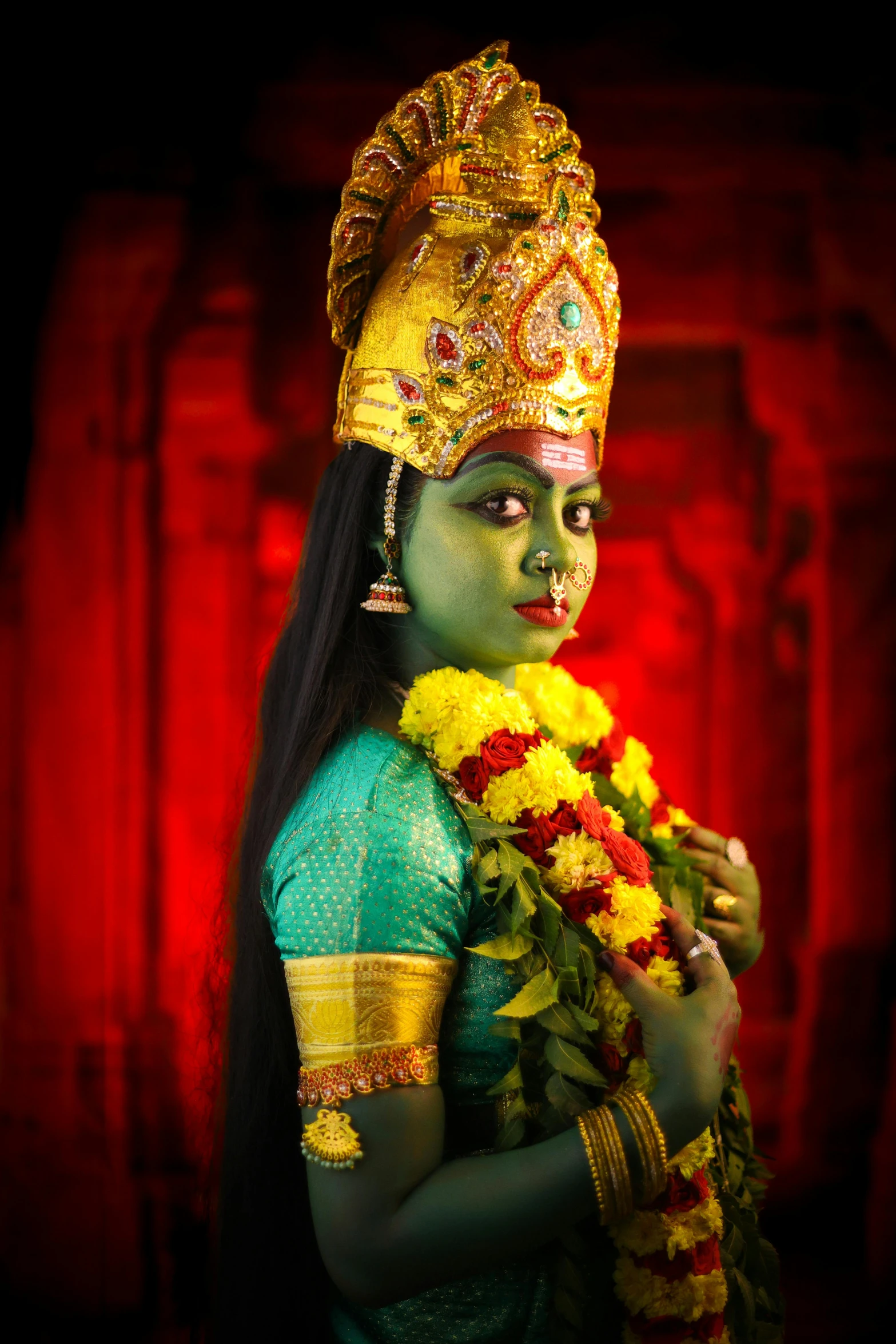 a woman with an artistic make up holding flowers