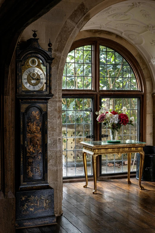 a large window on top of a wall above a gold table