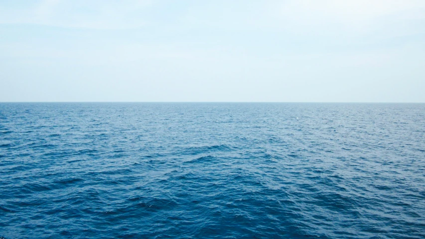 the ocean from the water surface with clouds