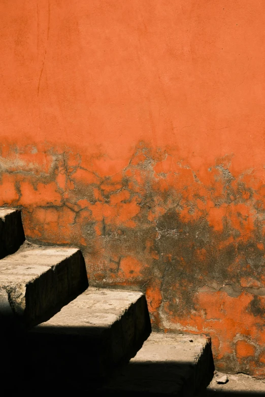 some steps with a red wall in the background