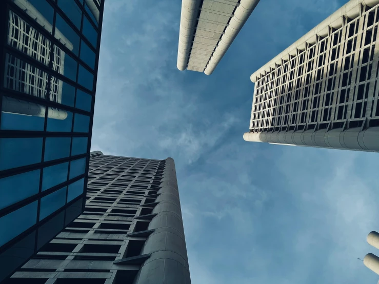 looking up at some buildings and the blue sky