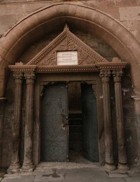 a large doorway with a clock mounted to it