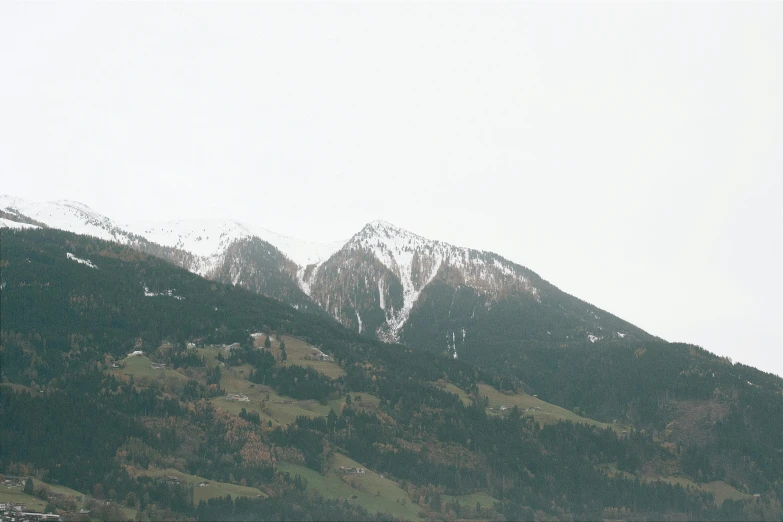 a mountain is covered in snow with a ski lift